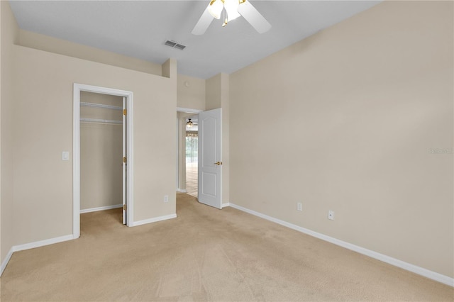 4065 Kingsley St, Clermont, FL 34711 - unfurnished bedroom featuring light carpet, a closet, a spacious closet, and ceiling fan