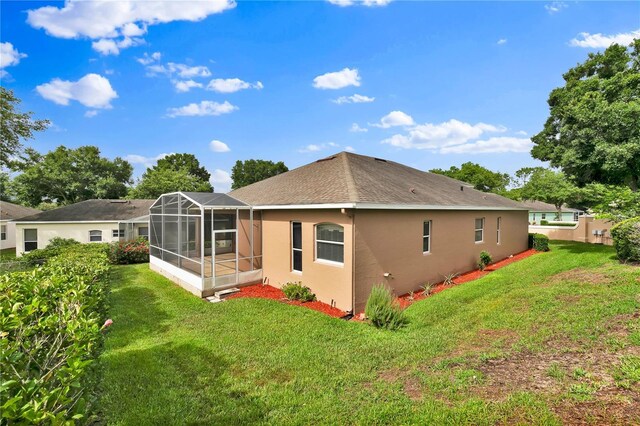 4065 Kingsley St, Clermont, FL 34711 - back of property featuring stucco siding, a yard, a lanai, and a shingled roof