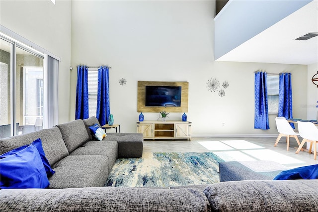 8974 Cabot Cliffs Dr, Davenport, FL 33896 - living area with wood finished floors, a towering ceiling, and baseboards