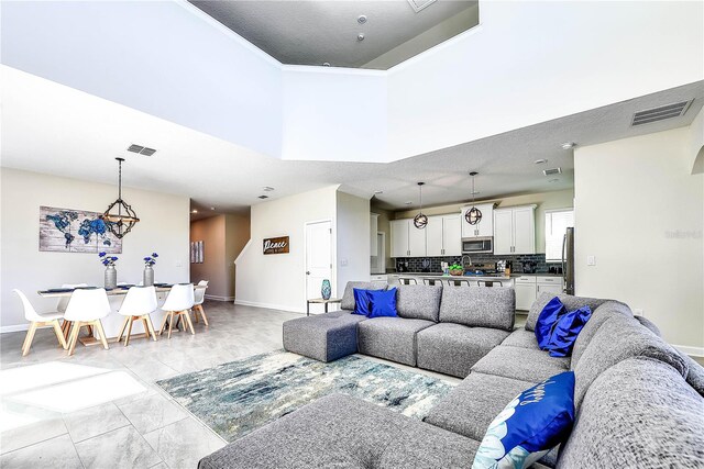 8974 Cabot Cliffs Dr, Davenport, FL 33896 - living area with baseboards, a towering ceiling, and ornamental molding