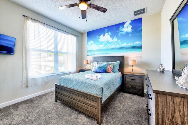 8974 Cabot Cliffs Dr, Davenport, FL 33896 - carpeted bedroom featuring baseboards, a textured ceiling, and a ceiling fan
