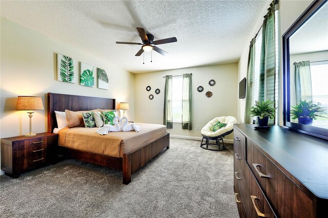 8974 Cabot Cliffs Dr, Davenport, FL 33896 - carpeted bedroom featuring ceiling fan, baseboards, and a textured ceiling
