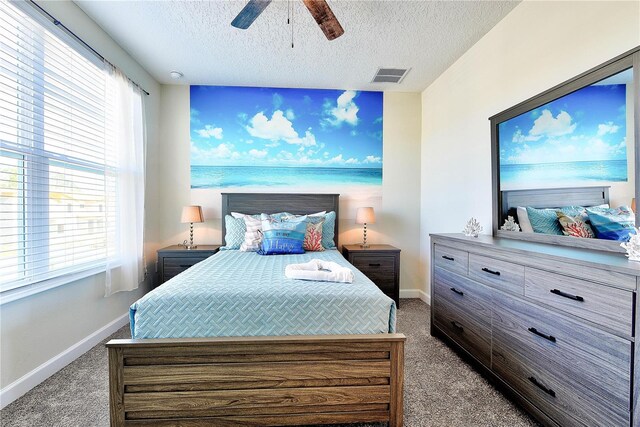 8974 Cabot Cliffs Dr, Davenport, FL 33896 - carpeted bedroom featuring baseboards, a textured ceiling, multiple windows, and ceiling fan
