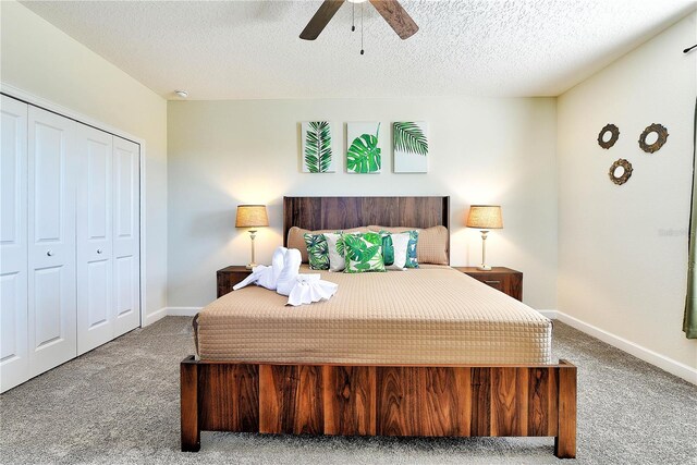 8974 Cabot Cliffs Dr, Davenport, FL 33896 - bedroom with carpet flooring, a closet, baseboards, a ceiling fan, and a textured ceiling