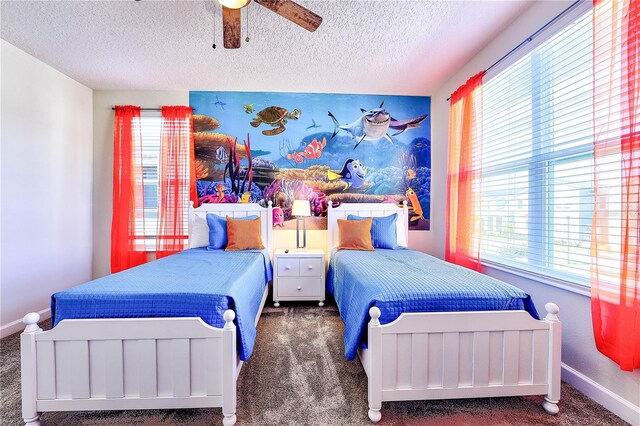 8974 Cabot Cliffs Dr, Davenport, FL 33896 - carpeted bedroom featuring multiple windows, a textured ceiling, baseboards, and ceiling fan