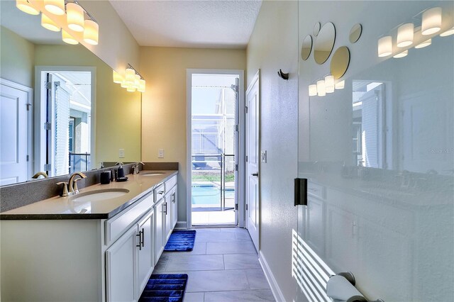 8974 Cabot Cliffs Dr, Davenport, FL 33896 - full bathroom with baseboards, double vanity, and tile patterned flooring