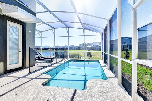 8974 Cabot Cliffs Dr, Davenport, FL 33896 - outdoor pool featuring a patio area, a residential view, and glass enclosure
