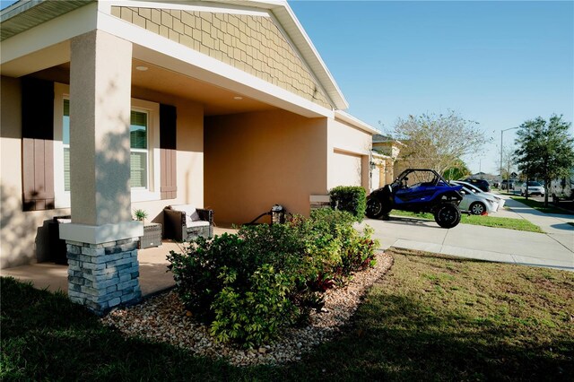 153 Taft Dr, Davenport, FL 33837 - view of side of property with stucco siding, driveway, and a garage