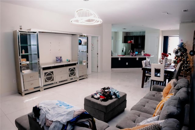 153 Taft Dr, Davenport, FL 33837 - living area with light tile patterned floors and a chandelier