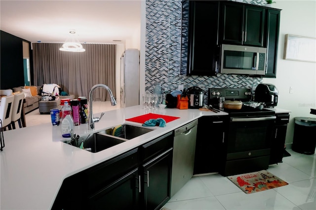153 Taft Dr, Davenport, FL 33837 - kitchen featuring stainless steel appliances, a sink, light countertops, and decorative backsplash