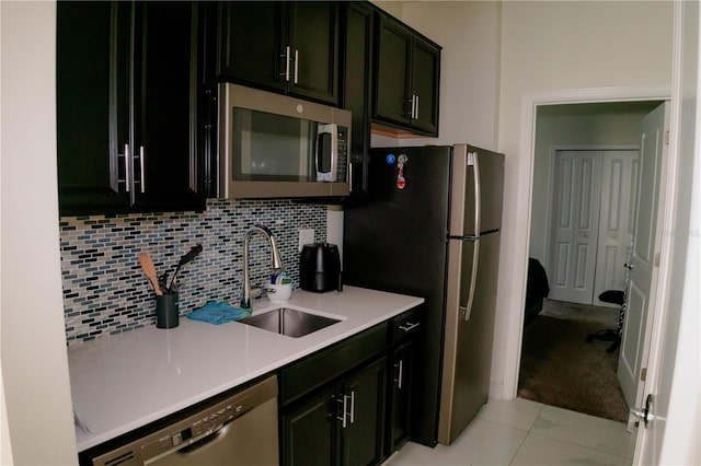 153 Taft Dr, Davenport, FL 33837 - kitchen with stainless steel appliances, a sink, light countertops, decorative backsplash, and light tile patterned floors
