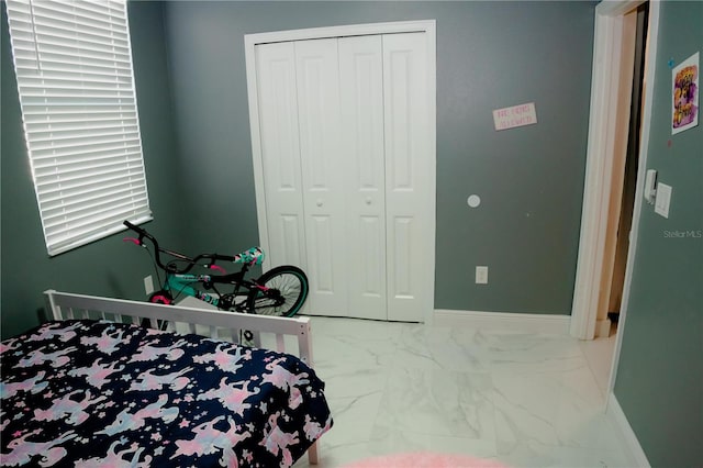 153 Taft Dr, Davenport, FL 33837 - bedroom with marble finish floors, a closet, and baseboards