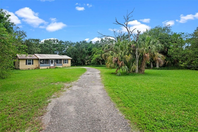 5381 Avocado Ave, Cocoa, FL 32926 - view of front of house with a front yard, gravel driveway, and crawl space