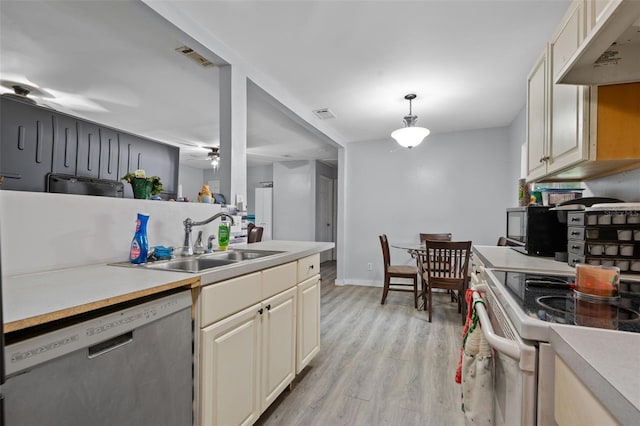 5381 Avocado Ave, Cocoa, FL 32926 - kitchen featuring stainless steel dishwasher, under cabinet range hood, a sink, light wood-type flooring, and range with electric cooktop