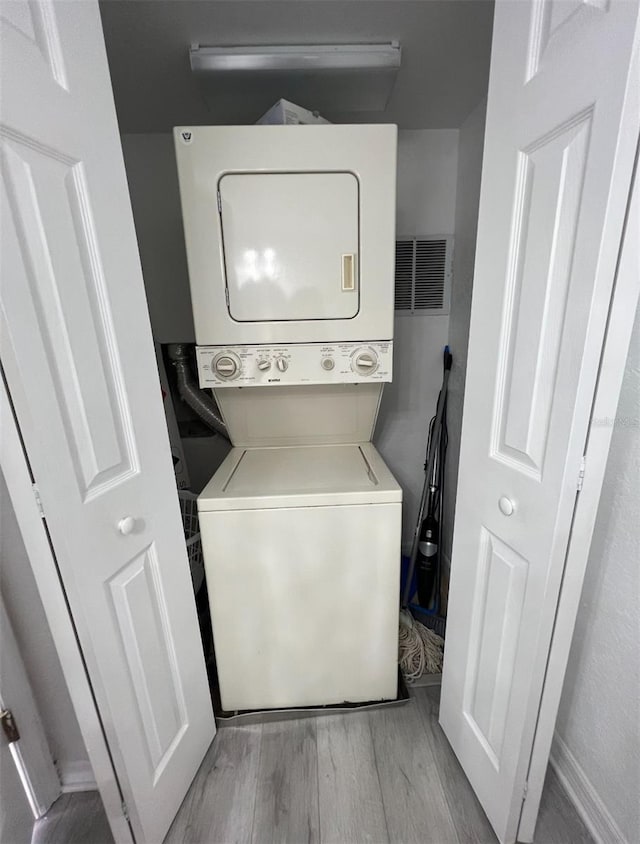 615 Terra Lago St, Davenport, FL 33897 - laundry area featuring stacked washer and clothes dryer and light wood-style floors