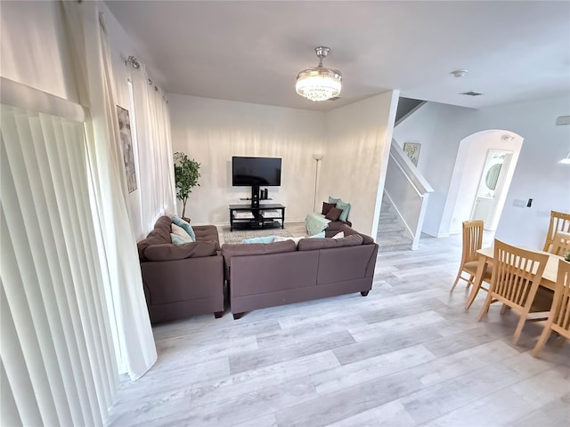 615 Terra Lago St, Davenport, FL 33897 - living area with arched walkways, stairs, and light wood finished floors