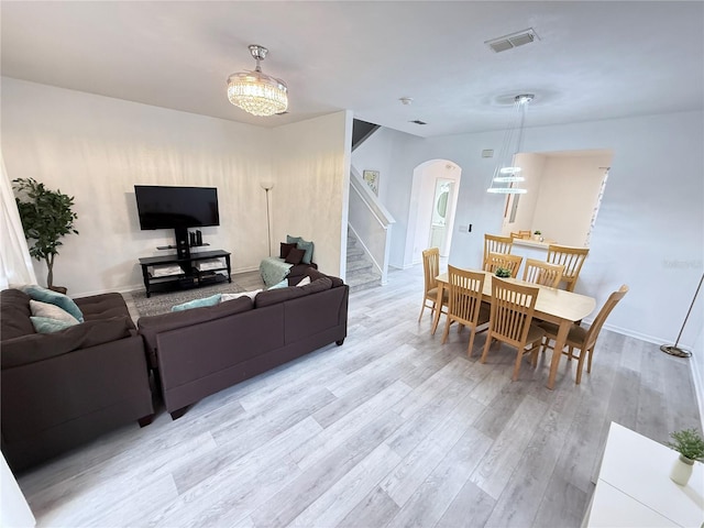 615 Terra Lago St, Davenport, FL 33897 - living room featuring arched walkways, light wood finished floors, and stairway