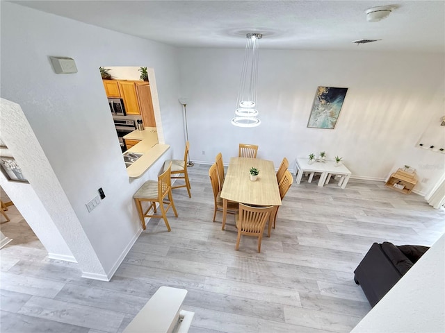 615 Terra Lago St, Davenport, FL 33897 - dining room featuring light wood-style floors and baseboards