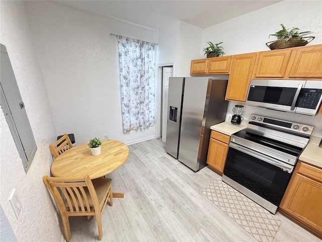 615 Terra Lago St, Davenport, FL 33897 - kitchen with stainless steel appliances, light wood-type flooring, light countertops, and electric panel