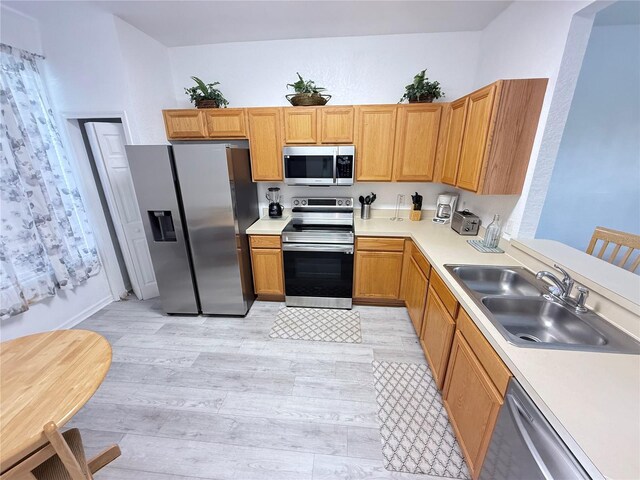615 Terra Lago St, Davenport, FL 33897 - kitchen featuring appliances with stainless steel finishes, light wood-style floors, and light countertops