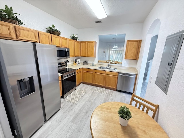 615 Terra Lago St, Davenport, FL 33897 - kitchen featuring appliances with stainless steel finishes, light wood finished floors, a textured wall, light countertops, and electric panel