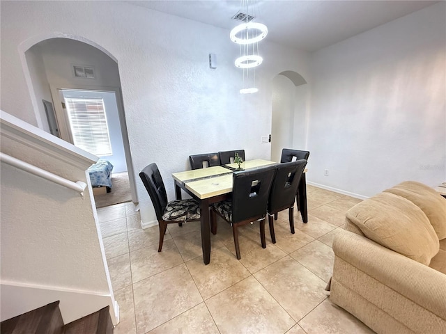 324 Palermo St, Davenport, FL 33897 - dining room featuring arched walkways, light tile patterned floors, and a textured wall