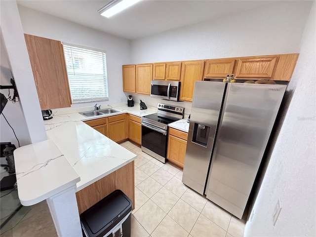 324 Palermo St, Davenport, FL 33897 - kitchen featuring stainless steel appliances, a peninsula, light stone countertops, and light tile patterned floors