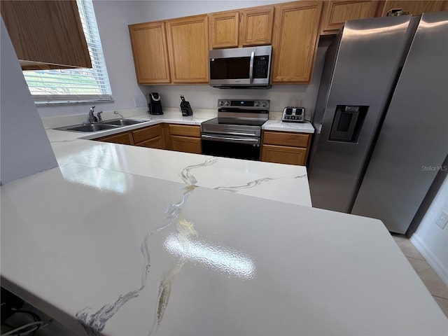324 Palermo St, Davenport, FL 33897 - kitchen with stainless steel appliances, light countertops, brown cabinets, and light tile patterned floors