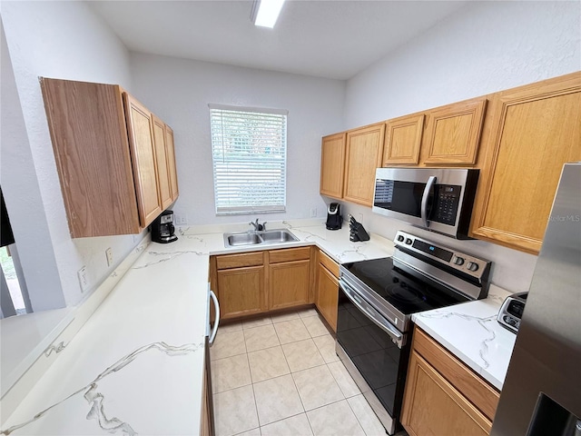 324 Palermo St, Davenport, FL 33897 - kitchen with stainless steel appliances, light tile patterned flooring, and light stone countertops