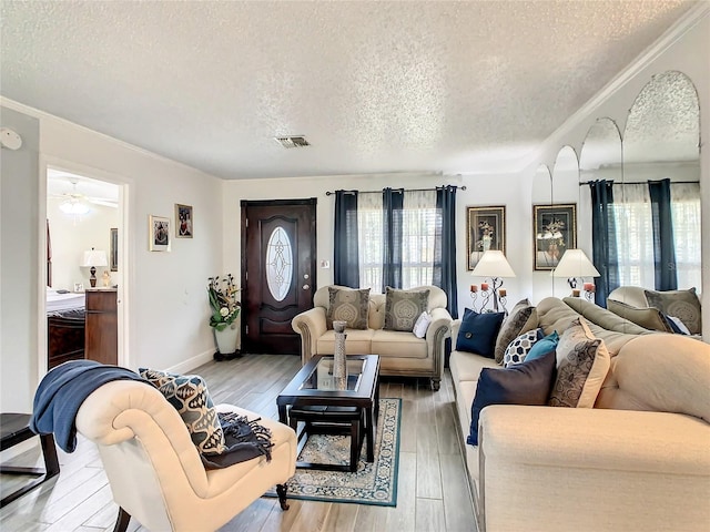 624 Royal Palm Dr, Kissimmee, FL 34743 - living room with a textured ceiling, light wood finished floors, crown molding, and a ceiling fan