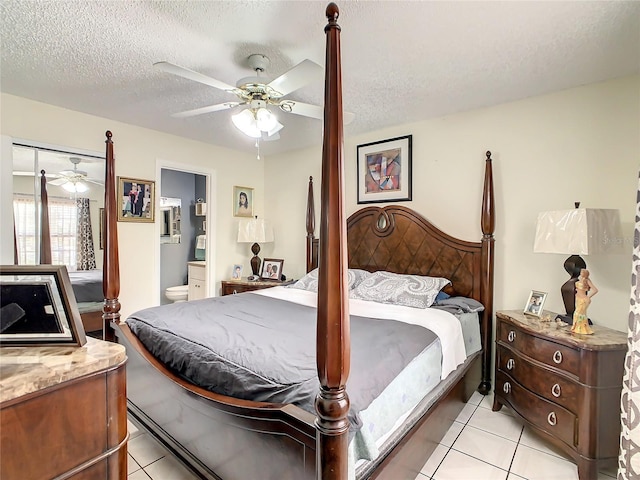 624 Royal Palm Dr, Kissimmee, FL 34743 - bedroom featuring light tile patterned floors, a textured ceiling, a ceiling fan, and ensuite bath