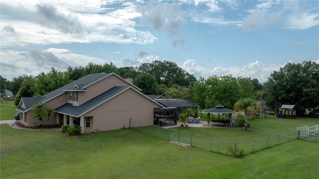 2851 Granada Blvd, Kissimmee, FL 34746 - view of side of property with a gazebo, a fenced backyard, and a chimney
