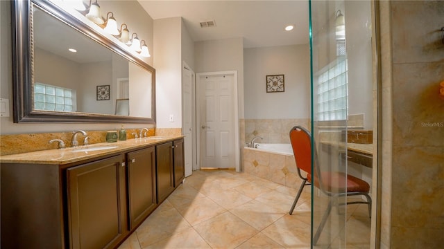 2851 Granada Blvd, Kissimmee, FL 34746 - bathroom featuring double vanity, a bath, and tile patterned floors