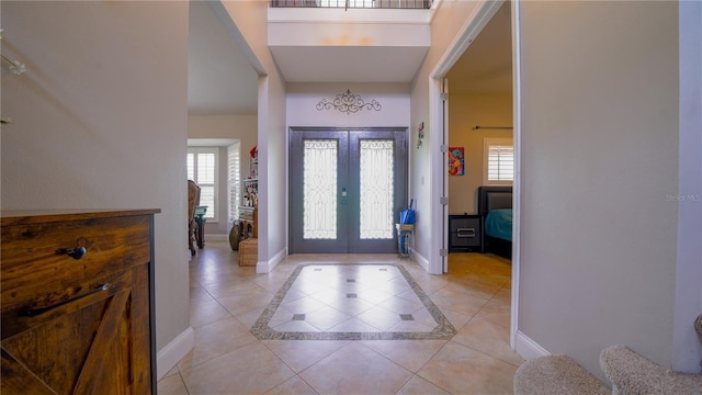 2851 Granada Blvd, Kissimmee, FL 34746 - entrance foyer with plenty of natural light, light tile patterned flooring, french doors, and inlaid floor details