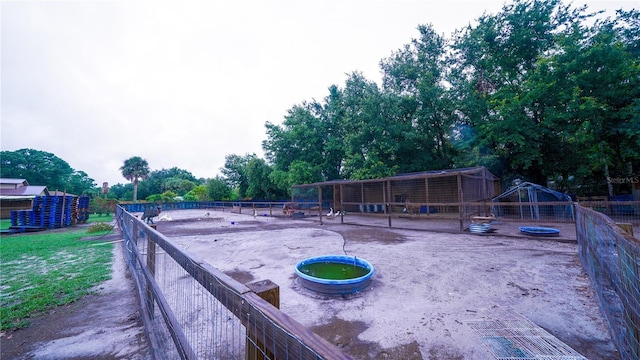 2851 Granada Blvd, Kissimmee, FL 34746 - view of yard with an exterior structure, an outdoor structure, and view of scattered trees