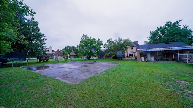 2851 Granada Blvd, Kissimmee, FL 34746 - view of green lawn with a playground, a trampoline, and basketball court