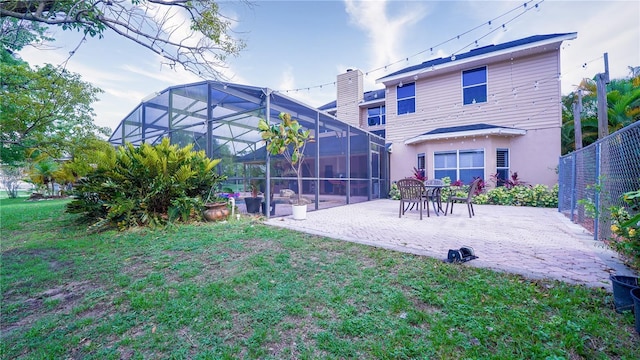 2851 Granada Blvd, Kissimmee, FL 34746 - rear view of property featuring a patio, stucco siding, and glass enclosure