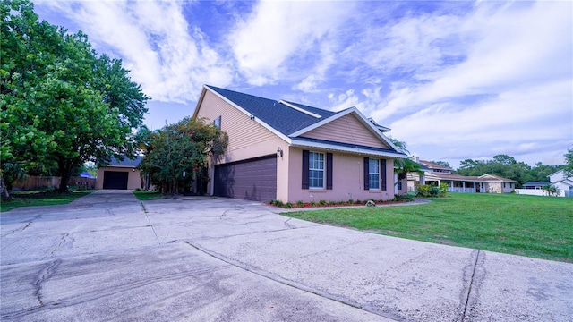 2851 Granada Blvd, Kissimmee, FL 34746 - view of side of home with a yard, driveway, stucco siding, and a garage