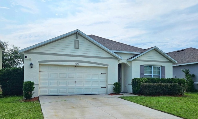 2479 White Lilly Dr, Kissimmee, FL 34747 - single story home with driveway, a garage, stucco siding, and a front lawn