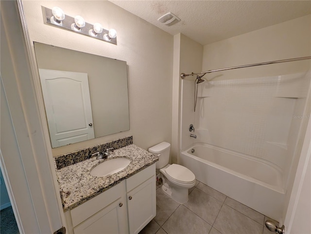 2479 White Lilly Dr, Kissimmee, FL 34747 - bathroom with vanity, toilet, bathtub / shower combination, tile patterned floors, and a textured ceiling