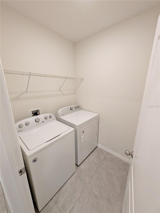 2479 White Lilly Dr, Kissimmee, FL 34747 - laundry area with independent washer and dryer, light tile patterned floors, and baseboards