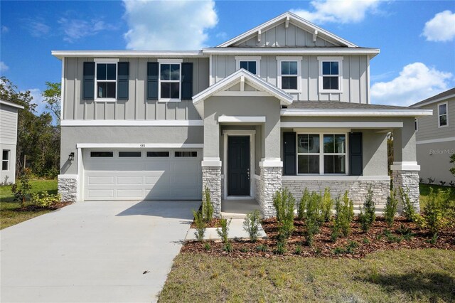 555 Summit River Dr, Apopka, FL 32712 - craftsman-style house with stone siding, board and batten siding, concrete driveway, and an attached garage