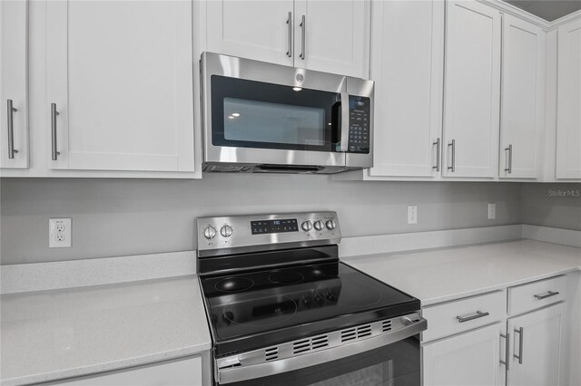 555 Summit River Dr, Apopka, FL 32712 - kitchen featuring stainless steel appliances, light countertops, and white cabinets