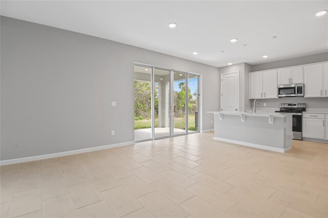 555 Summit River Dr, Apopka, FL 32712 - kitchen featuring stainless steel appliances, baseboards, light countertops, a sink, and recessed lighting