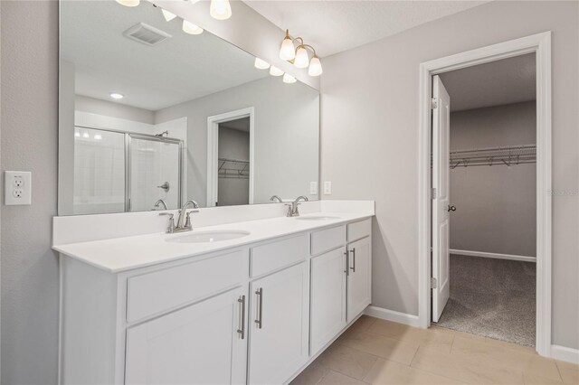 555 Summit River Dr, Apopka, FL 32712 - full bath featuring a spacious closet, double vanity, a shower stall, and baseboards