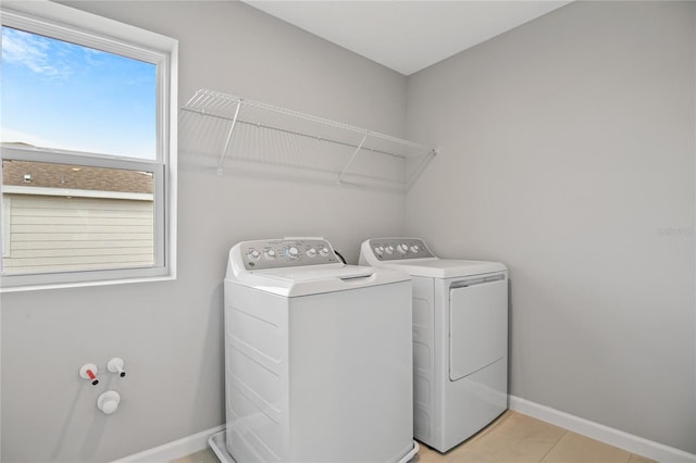 555 Summit River Dr, Apopka, FL 32712 - washroom with washer and dryer, baseboards, and light tile patterned floors