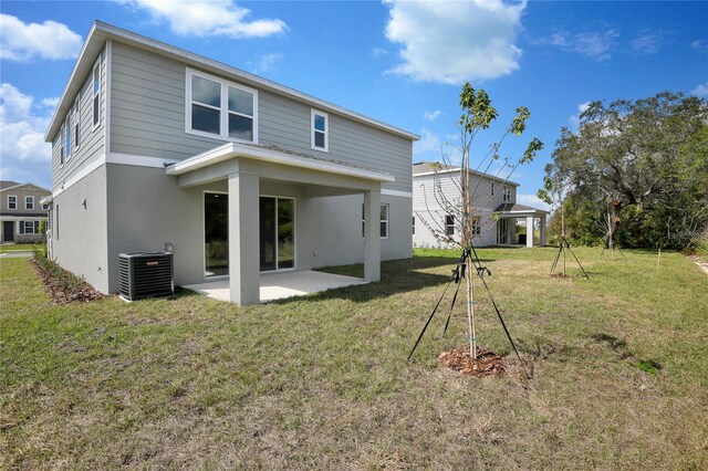 555 Summit River Dr, Apopka, FL 32712 - back of property with a patio area, central air condition unit, a yard, and stucco siding