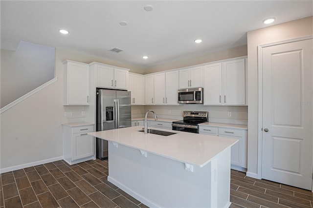 565 Summit River Dr, Apopka, FL 32712 - kitchen with stainless steel appliances, a sink, wood finish floors, white cabinetry, and light countertops