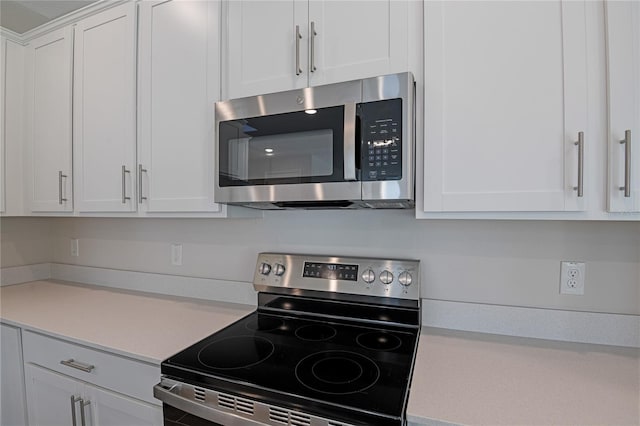 565 Summit River Dr, Apopka, FL 32712 - kitchen featuring appliances with stainless steel finishes, light countertops, and white cabinets