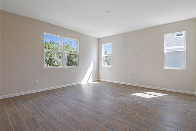 565 Summit River Dr, Apopka, FL 32712 - unfurnished room featuring dark wood-style flooring, baseboards, and healthy amount of natural light